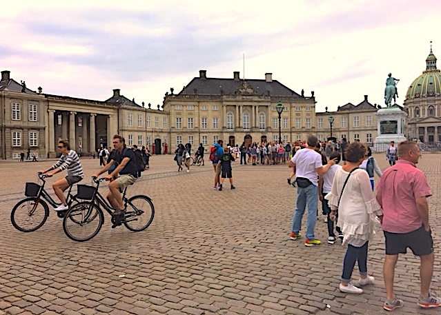 Cycling Past the Amalienborg Palace in the Historic Center
